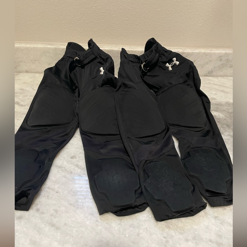 2 PAIRS! Under armour youth football pants. Black, size small.